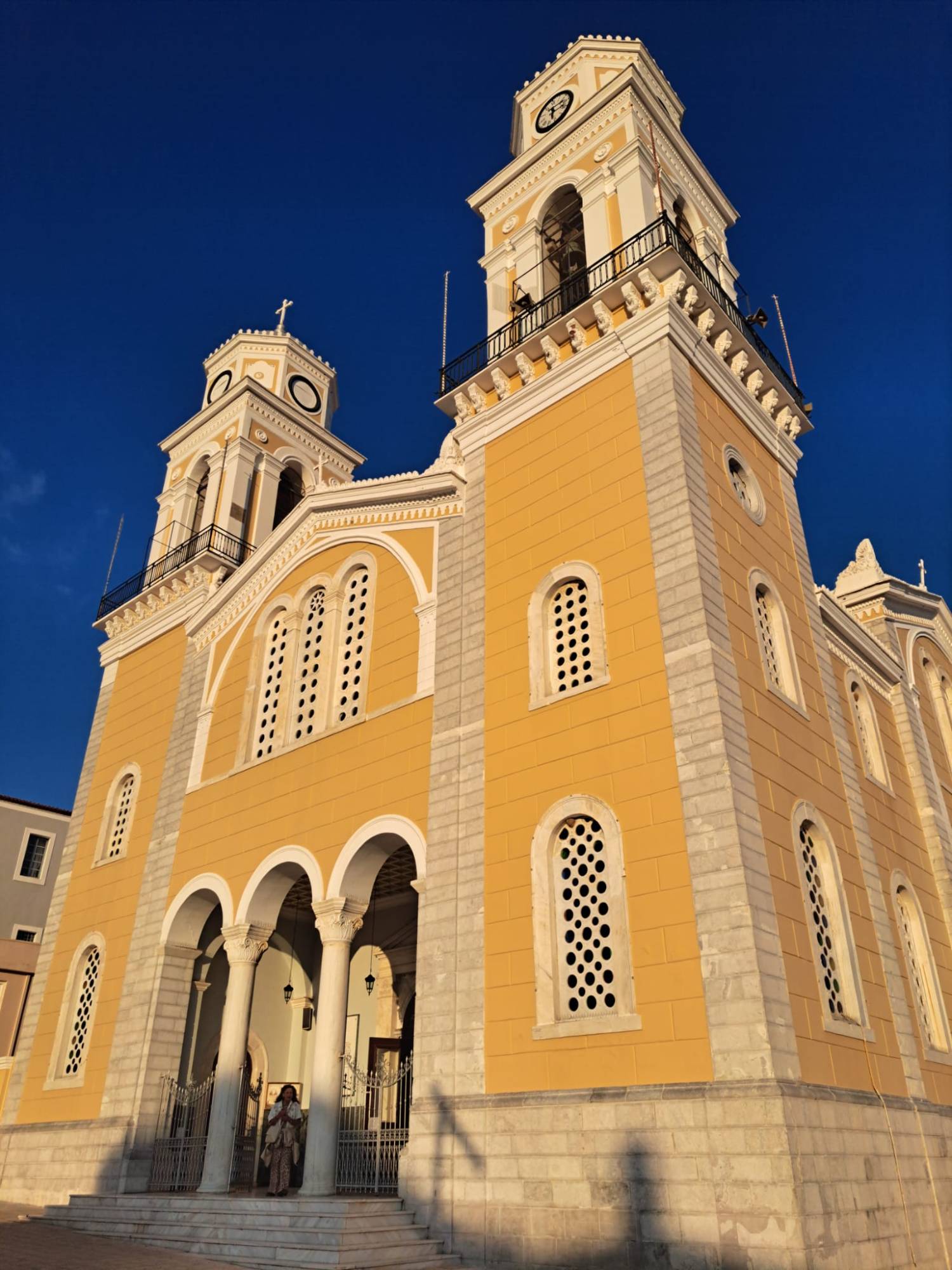 Yellow church with two bell towers in Kalamata